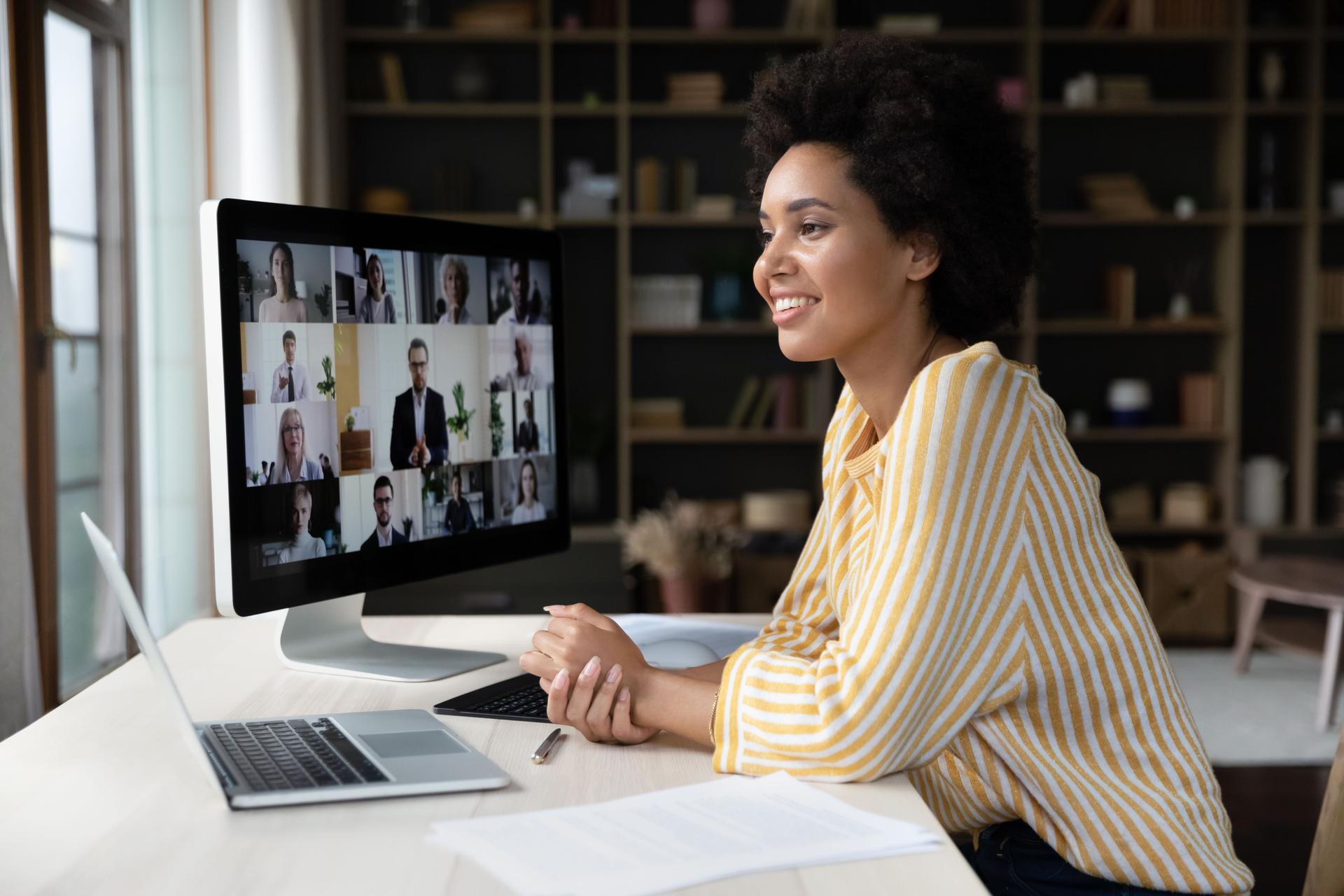 Happy African American employee talking on video conference call