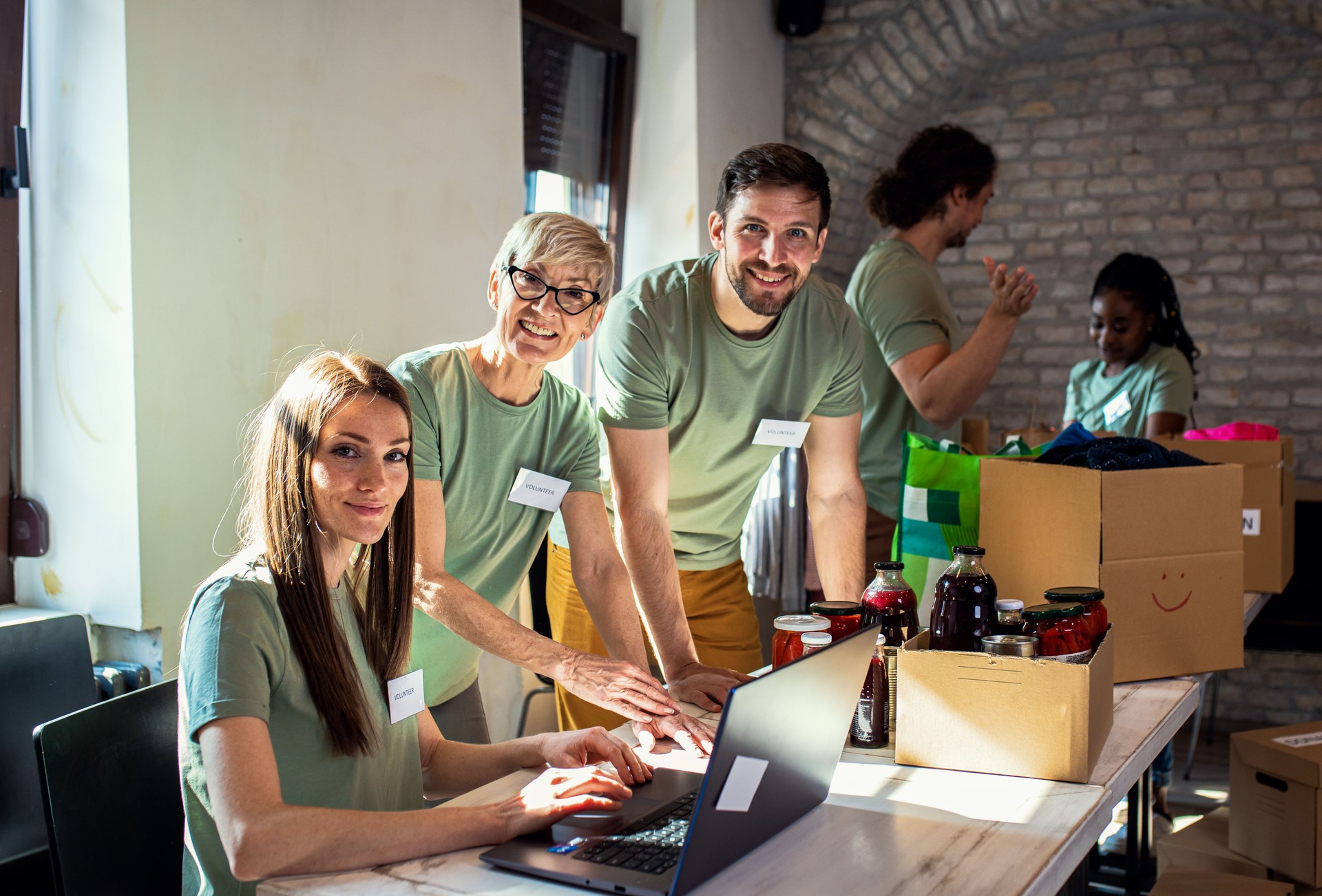 Group of volunteers working in community charity donation center.